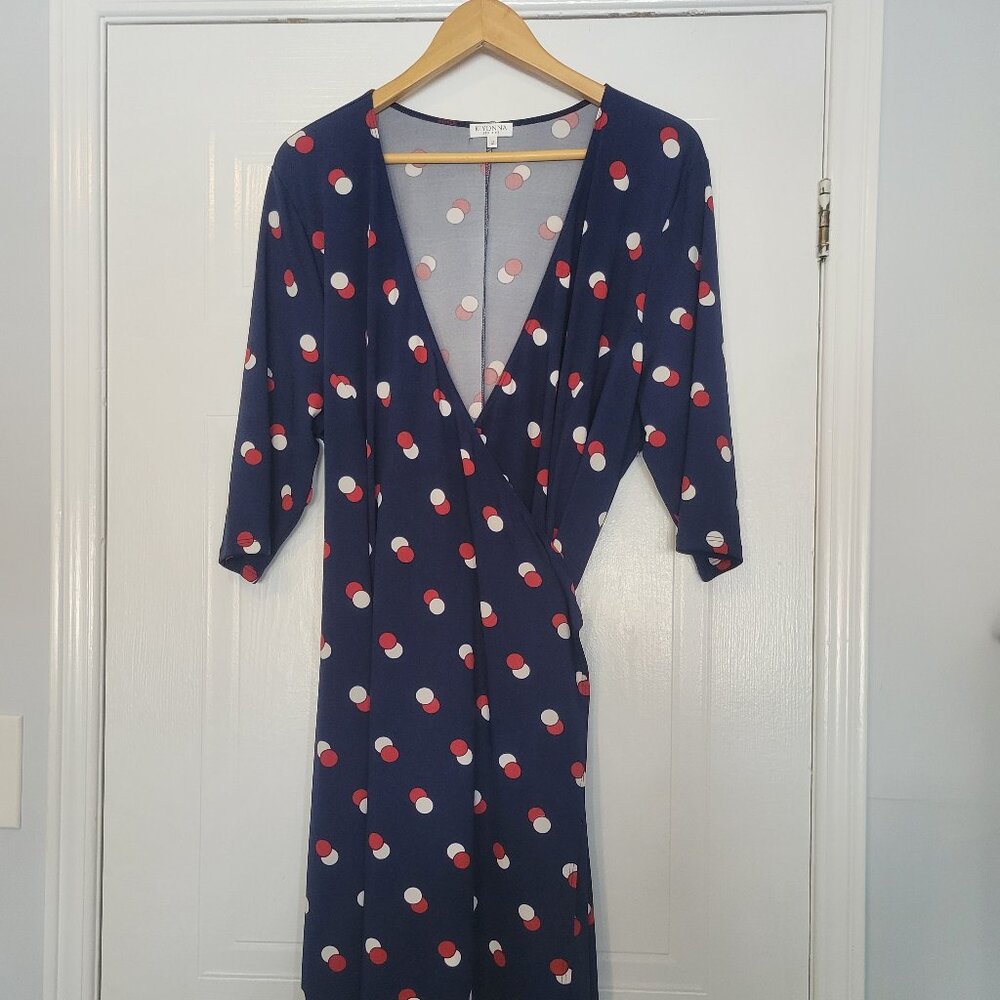 Navy wrap dress with large red and white dots.
